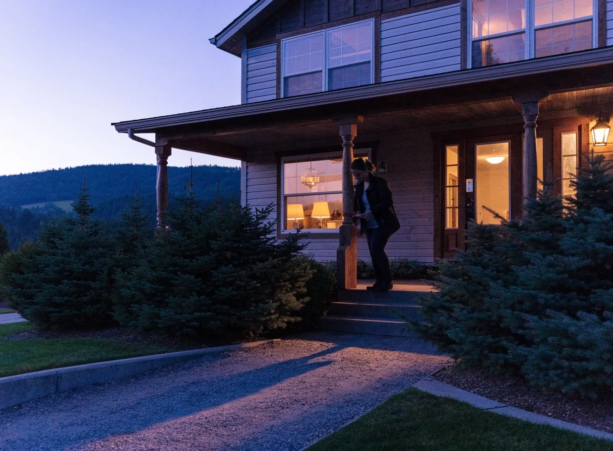 Quiet Kalispell street with lit porches at dusk